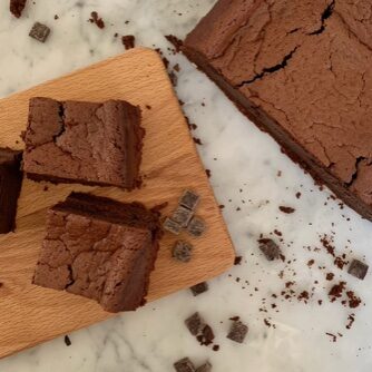 A selection of flour-free chocolate cakes, cut into squares, laid out on a chopping board
